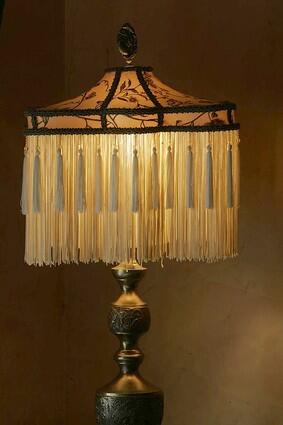 DETAILS: A custom fringed lamp adds elegance; a velvet curtain is beaded, embroidered and appliqued.