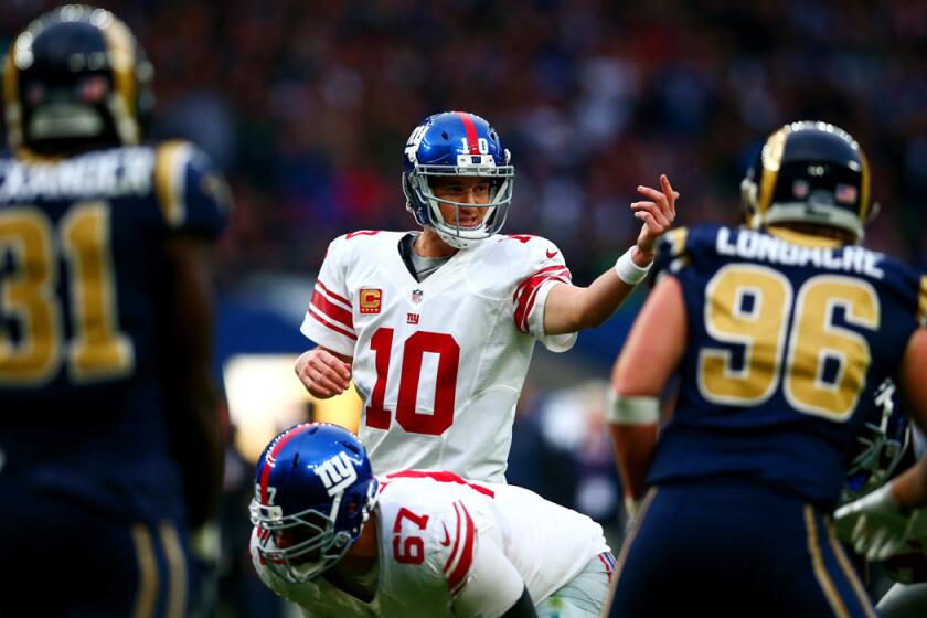 Quarterback Eli Manning (10) signals his teammates during the NFL International series game between the Giants and Rams in London on Sunday.