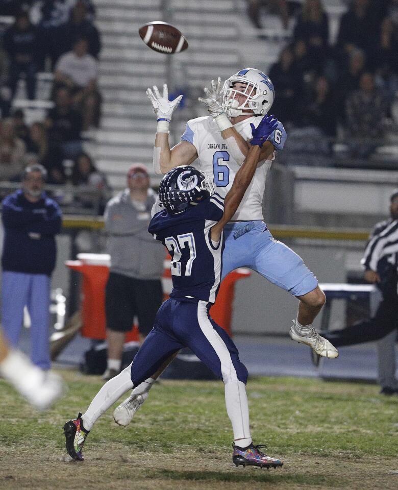 Corona del Mar High wide receiver John Humphreys jumps over Camarillo's Izaiah Lazaro to make a catch in the second quarter of the CIF Southern Section Division 4 semifinal road game on Friday.