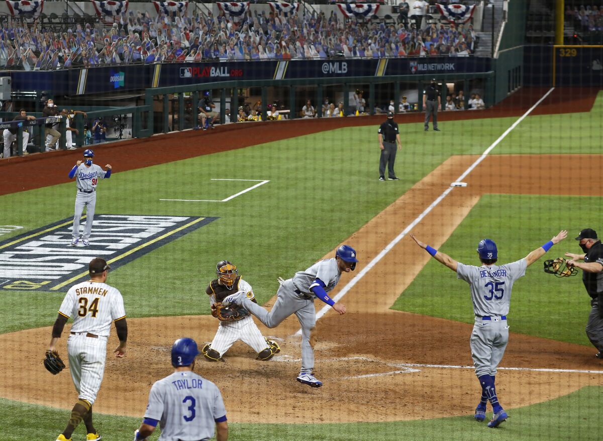 A.J. Pollock scores during the Dodgers' five-run third inning in Game 3 of the National League Division Series.