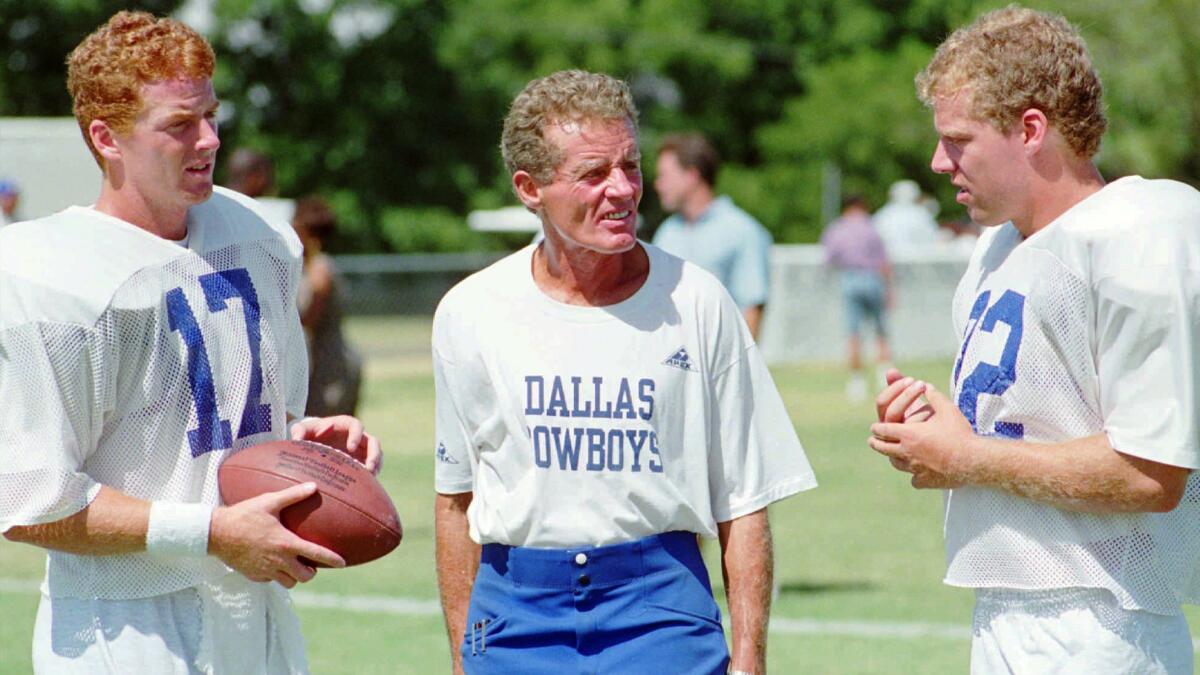 Jim Garrett, center, speaks with his sons Jason, left, and Judd during a Dallas Cowboys training camp session in July 1993.