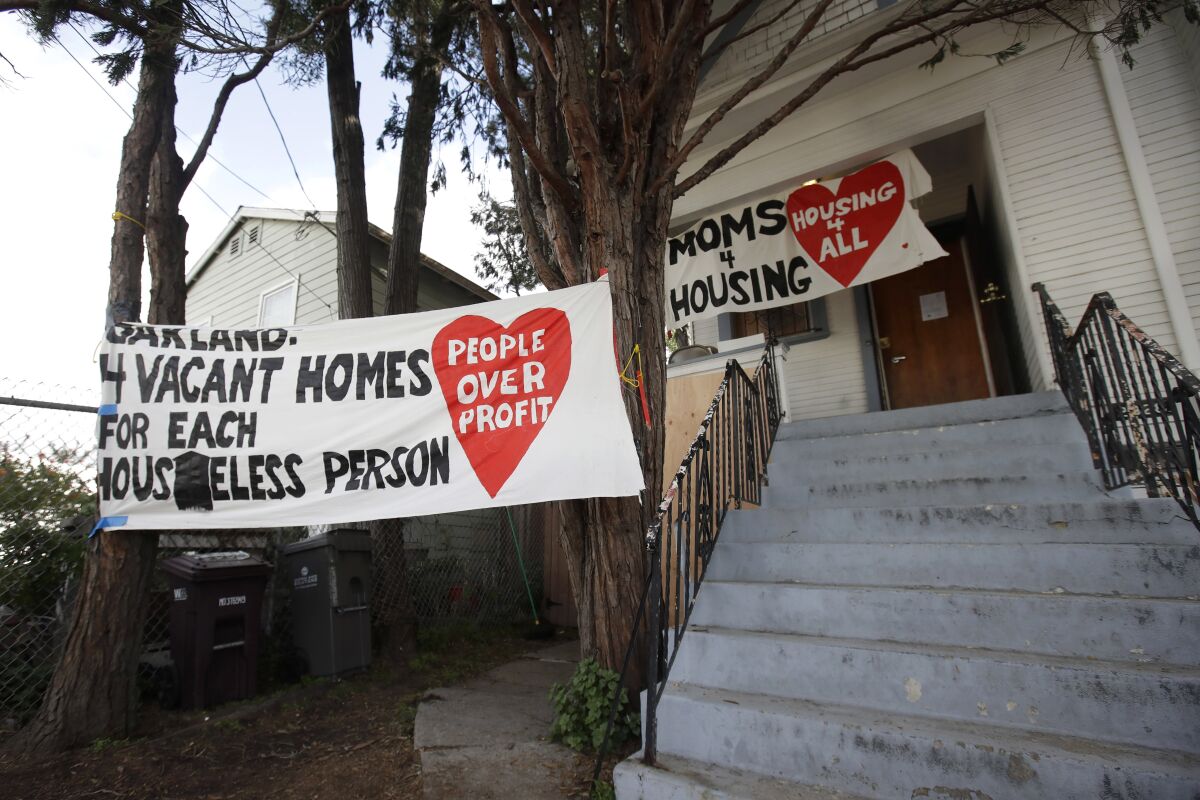Signs are posted outside of a house that was occupied by homeless women in Oakland.