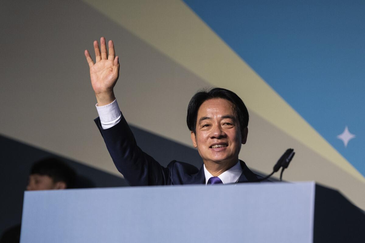 Taiwanese President-elect Lai Ching-te waves from a lectern