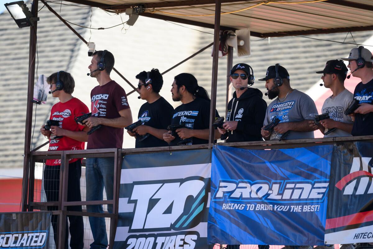 Drivers look on as they race their RC cars