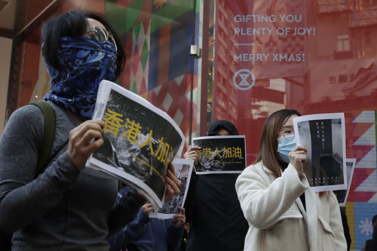 Pro-democracy supporters and office workers join a lunchtime protest Dec. 11 at Causeway Bay in Hong Kong.