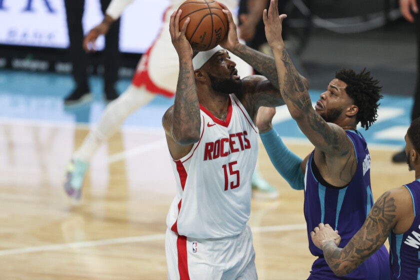 Houston Rockets center DeMarcus Cousins (15) shoots over Charlotte Hornets forward Miles Bridges in the first half of an NBA basketball game in Charlotte, N.C., Monday, Feb. 8, 2021. (AP Photo/Nell Redmond)