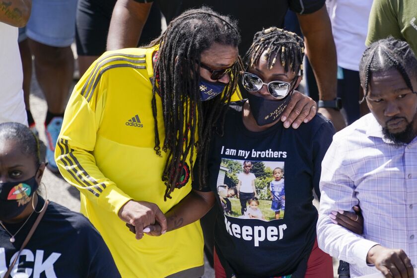 Jacob Blake's sister Letetra Widman, center, and uncle Justin Blake, left, march at a rally for Jacob Blake Saturday, Aug. 29, 2020, in Kenosha, Wis. (AP Photo/Morry Gash)