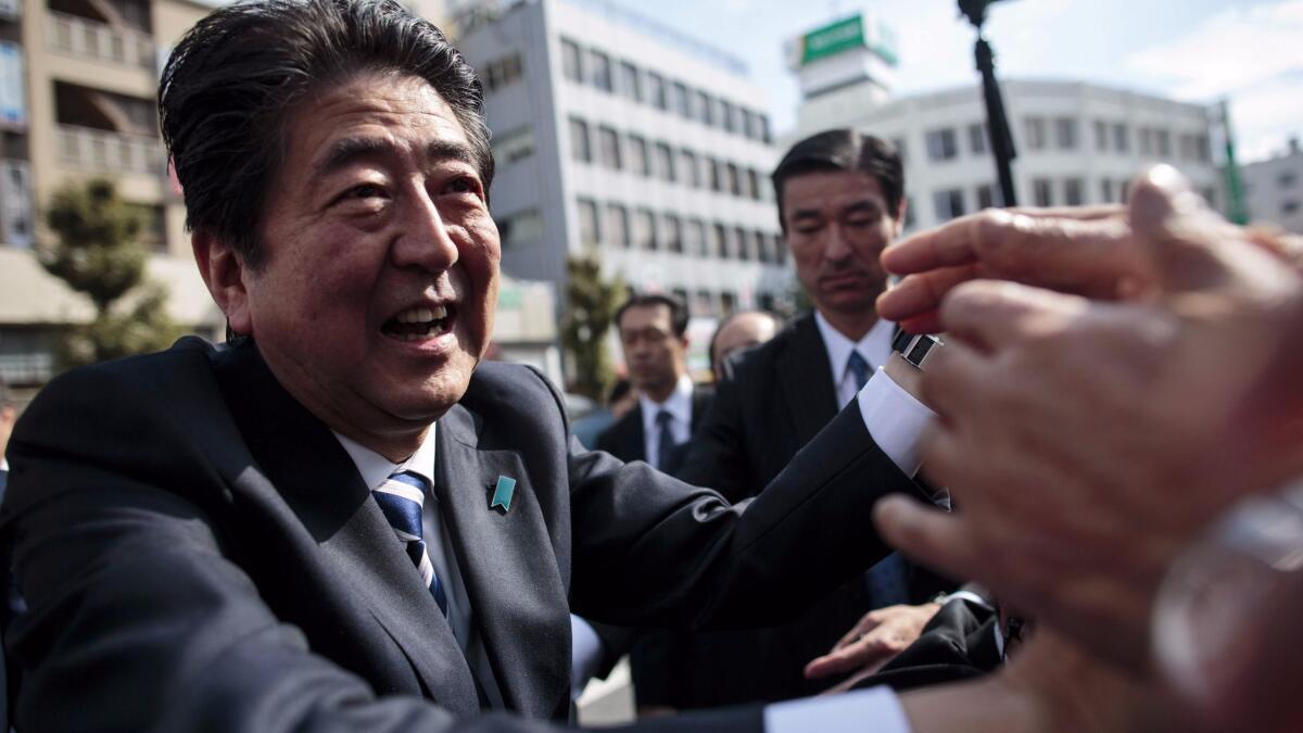 Japanese Prime Minister Shinzo Abe greets supporters at a campaign appearance Wednesday in Saitama.