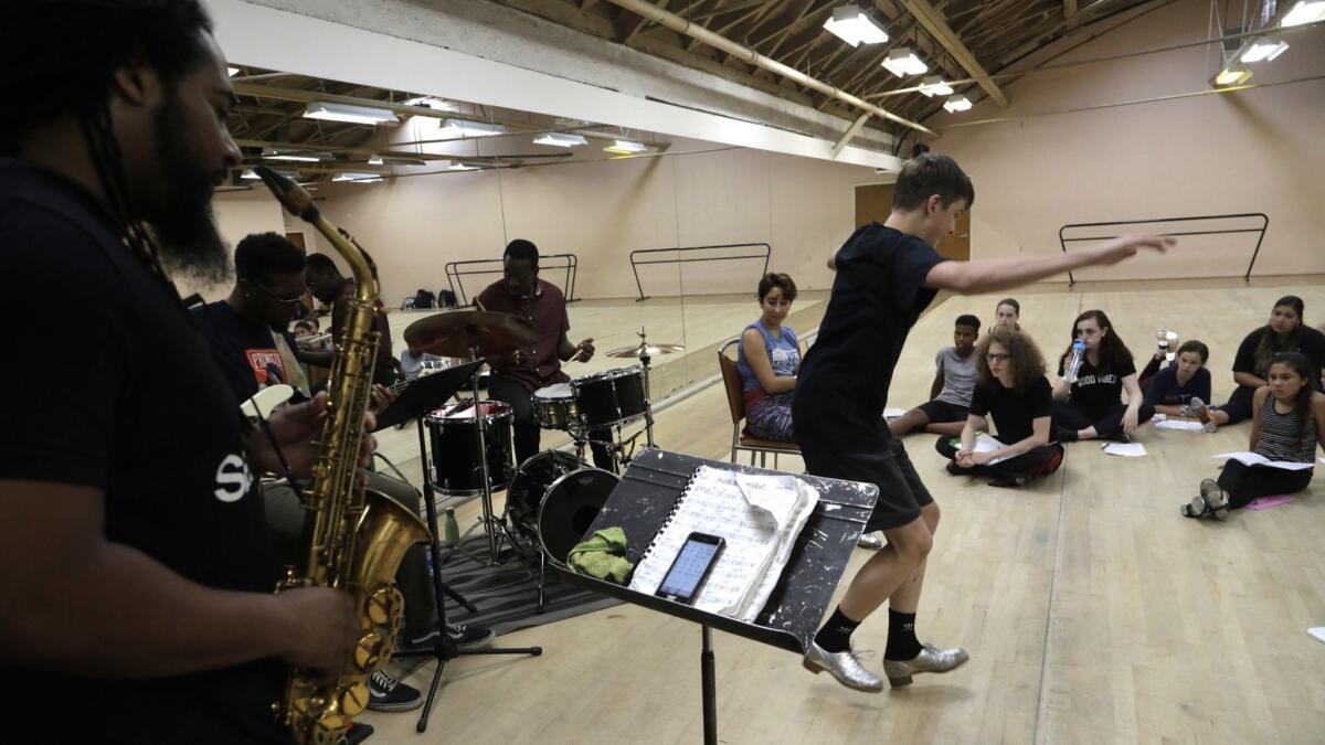 Colton Hagler, 15, taps with a live band during a week-long tap dance workshop at the Dance Arts Academy in Los Angeles. The school closed because the building was sold.