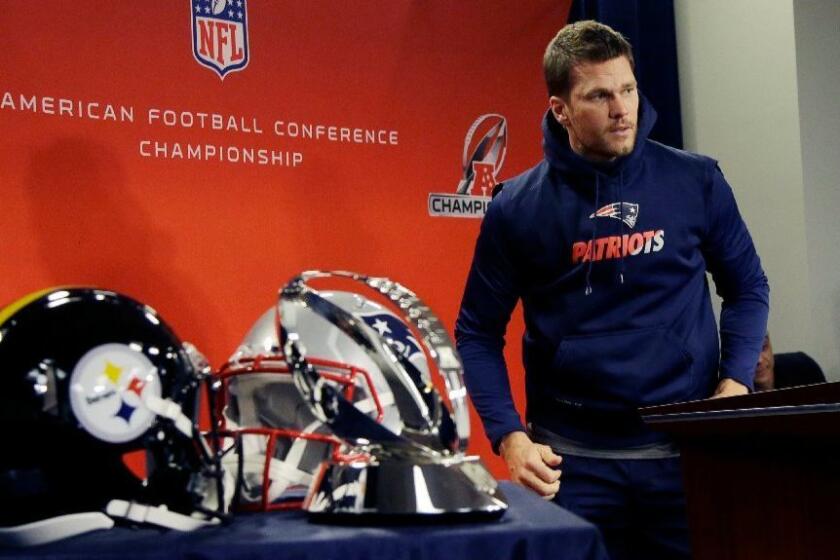 Patriots quarterback Tom Brady heads to a podium for a news conference on Jan. 18 ahead of New England's AFC championship game against the Pittsburgh Steelers.