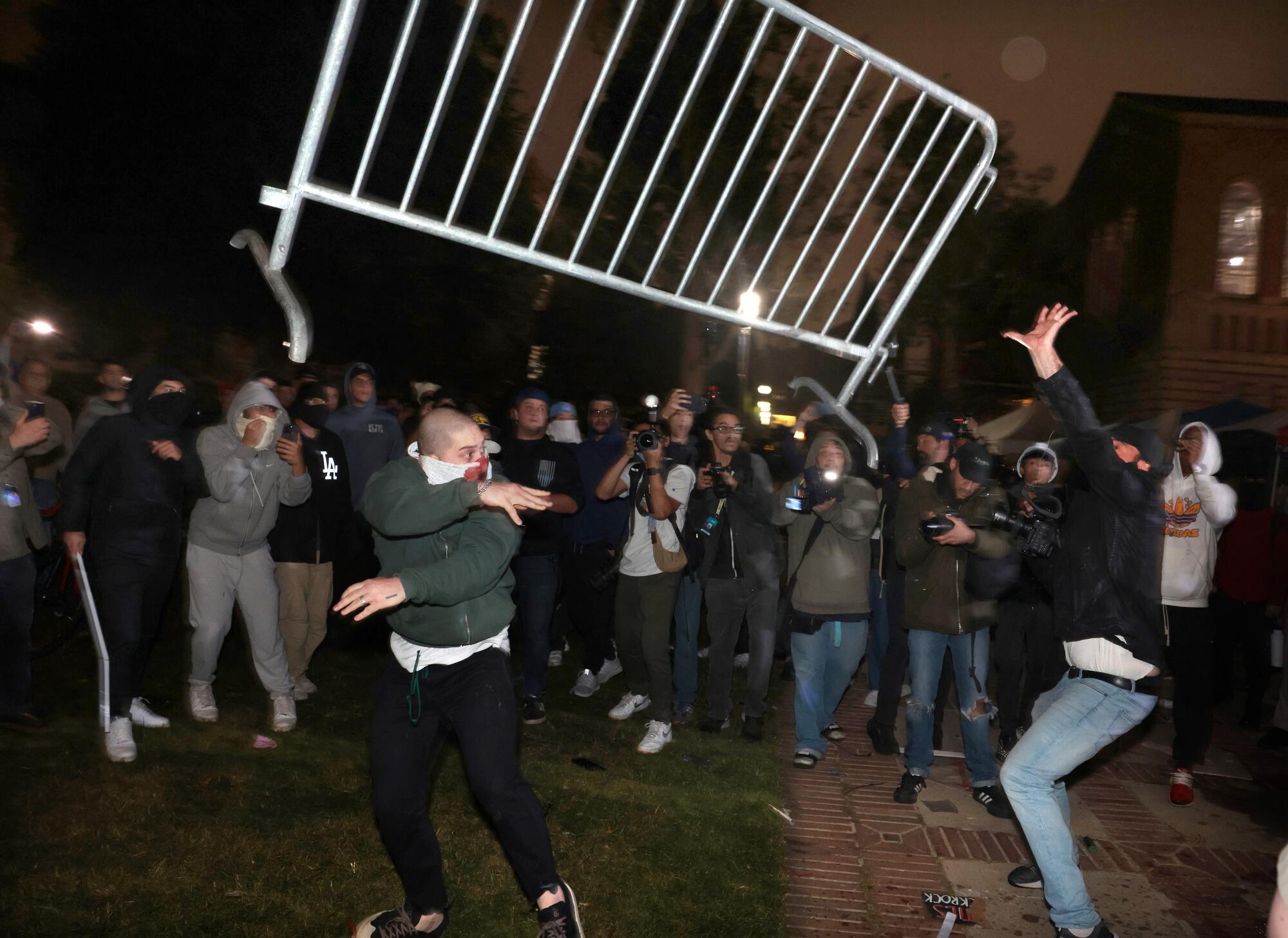 Pro-Palestinian protestors and pro-Israeli supporters clash at an encampment at UCLA early Wednesday morning.