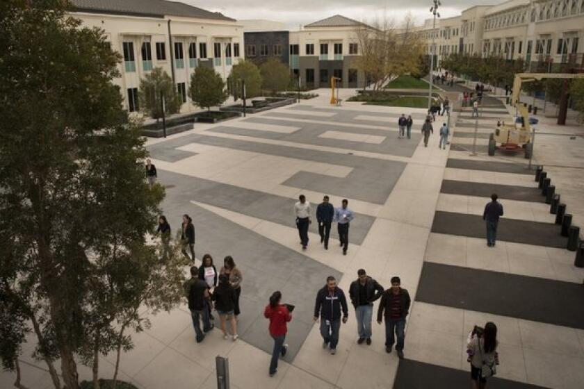 Twenty-four hours after Facebook opened its polls, more than 100,000 users have cast their votes 10 to 1 against Facebook's proposed changes to its privacy and data-sharing policies. Above, Facebook employees walk the grounds of Facebook's Menlo Park, Calif., headquarters.