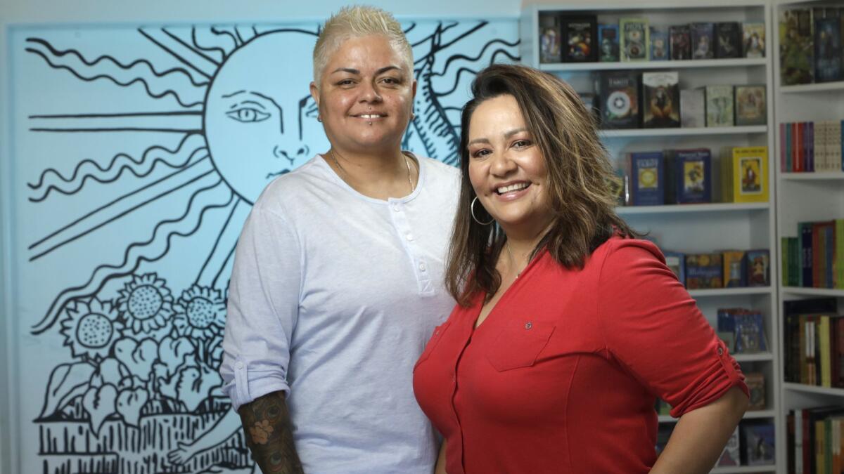 Alex Naranjo, left, and Marlene Vargas opened the first House of Intuition store in Los Angeles in 2010. This one in Highland Park is their sixth and newest store specializing in spiritual goods and gifts.