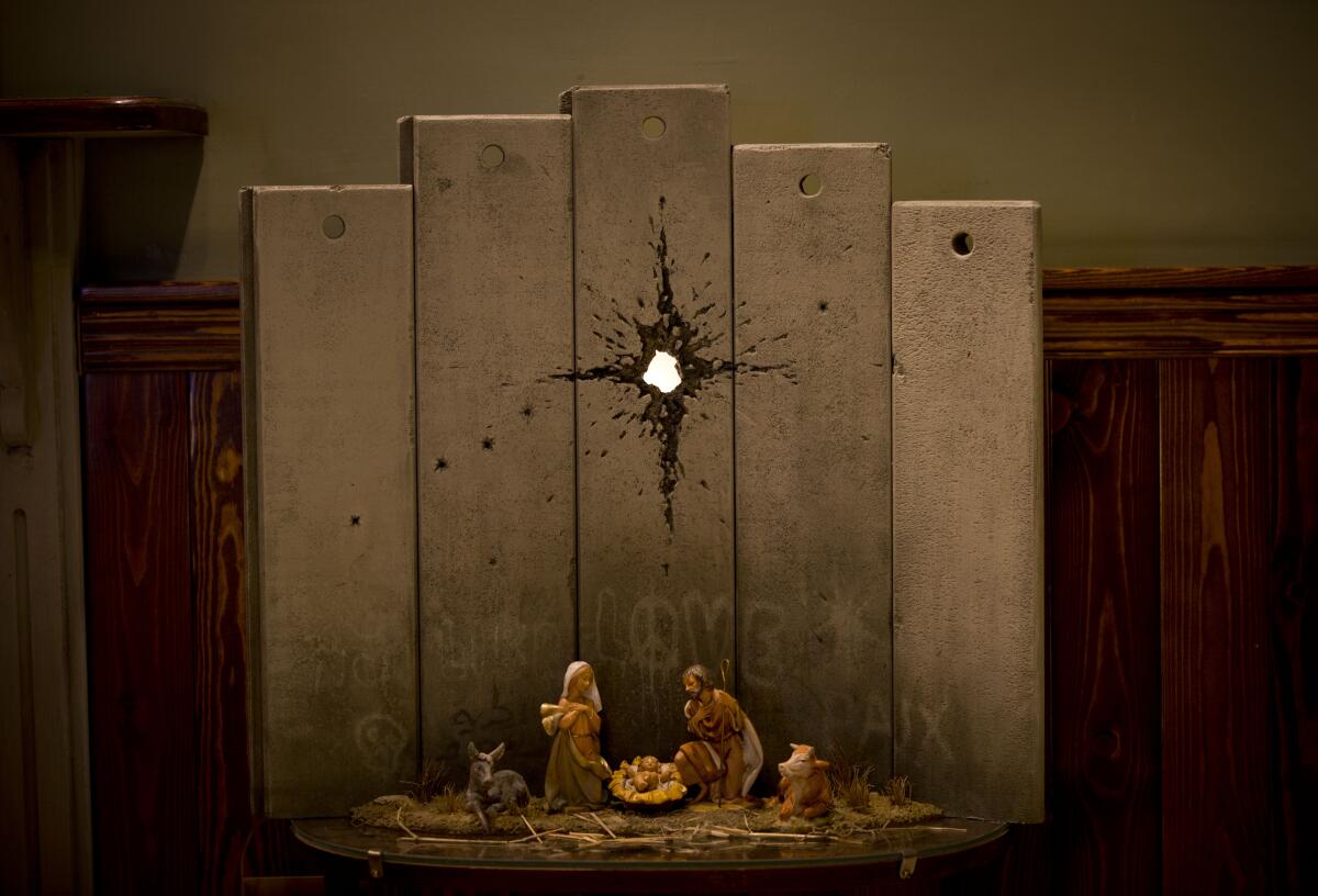 The new Banksy artwork "Scar of Bethlehem" has been installed at the Walled Off Hotel in Bethlehem.