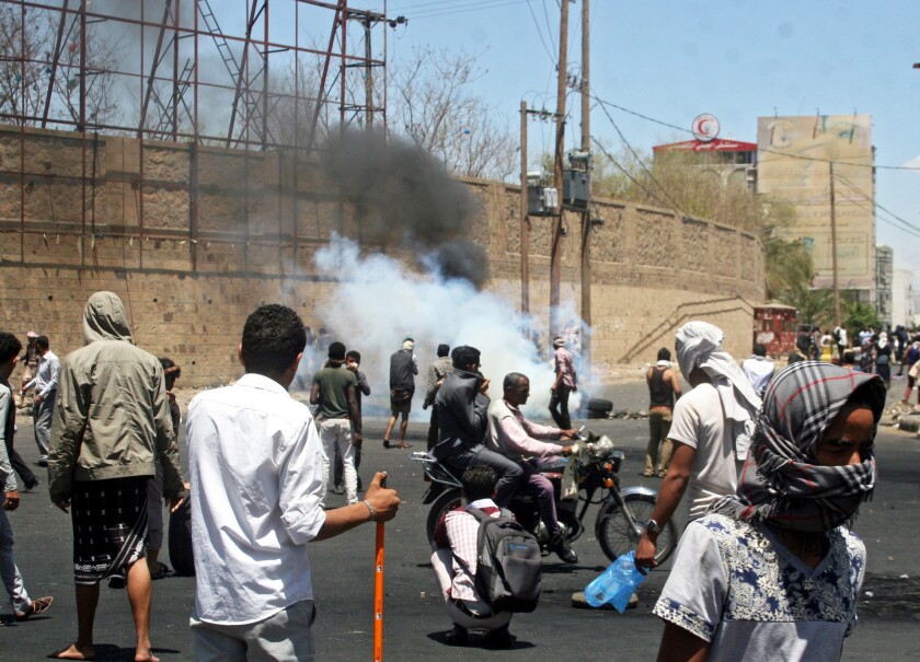 Yemenis clash with Houthi militiamen during a protest against the Houthi takeover of state facilities in the city of Taiz on March 22. Yemen's Shiite Houthi rebels swept into the strategic city, capturing the airport, airbase and a court complex.