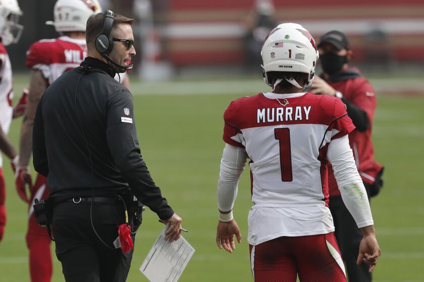 Arizona Cardinals head coach Kliff Kingsbury talks with quarterback Kyler Murray (1).