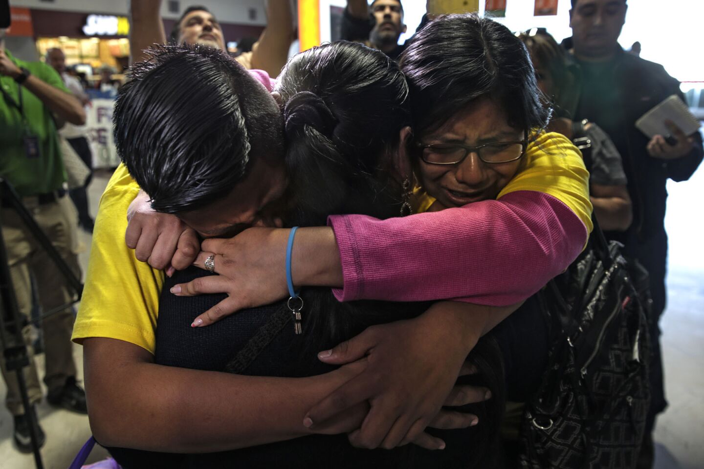 Maria de Lourdes Molina Garcia reunites Tuesday with her children, Iris, right, and Luis Hipolito at the Abraham Gonzalez International Airport in Ciudad Juarez during Pope Francis' visit to Mexico. Luis and Iris live in Los Angeles, separated from their mother, who lives in Oaxaca, Mexico.