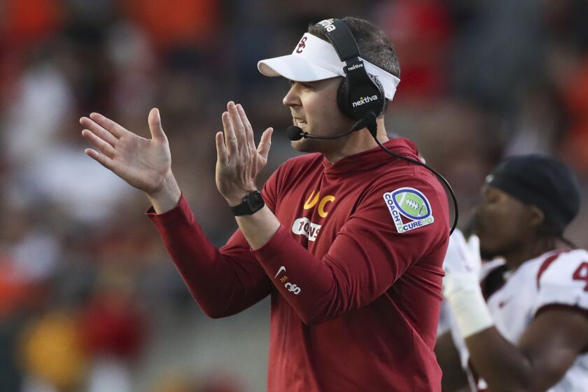Southern California coach Lincoln Riley applauds during the first half.