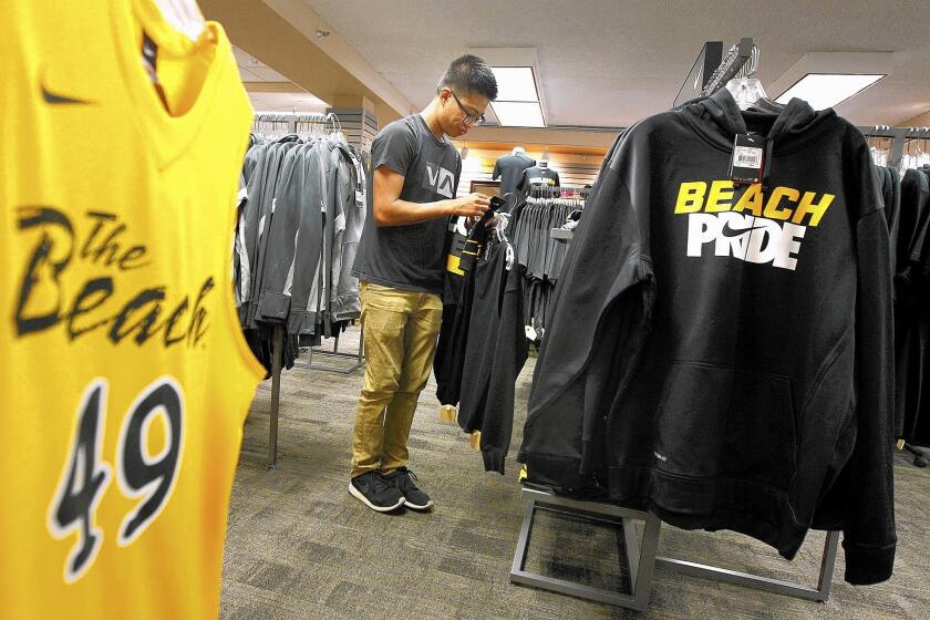 A student at Cal State Long Beach's bookstore looks at merchandise branded with the campus' unofficial nickname, the Beach.