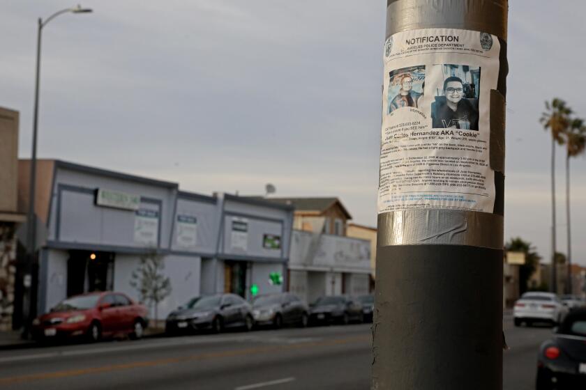 LOS ANGELES, CA - FEBRUARY 03: A Los Angeles Police Department missing person notification for Juan Carlos Hernandez hangs across the street from where he worked at VIP Collective marijuana dispensary along the 8100 block of Western Ave. Yajaira Hernandez's 21-year-old son, Juan Carlos Hernandez, went to work one afternoon in September 2020 and never came home, on Wednesday, Feb. 3, 2021 in Los Angeles, CA. She looked for her son for nearly two months, until the police told her they'd found his remains in the Mojave desert, 150 miles from where he was last seen at his job at a marijuana dispensary in South Los Angeles. (Gary Coronado / Los Angeles Times)