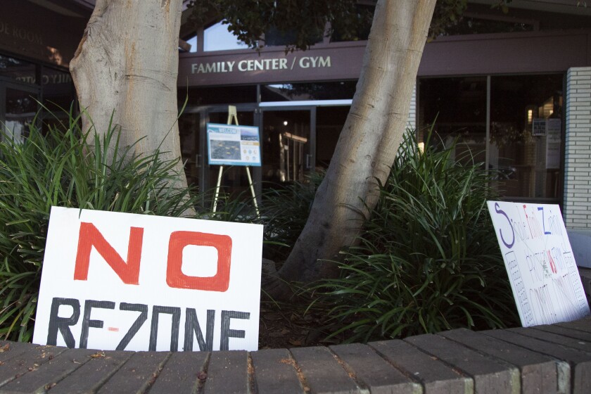A sign reads "no re-zone" sits outside a community open house