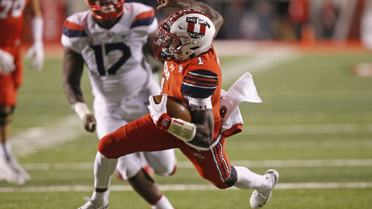 Utah quarterback Tyler Huntley carries the ball against Arizona during the first half on Friday in Salt Lake City.