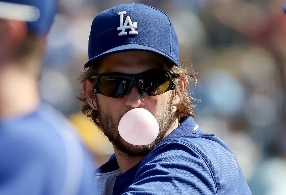 Dodgers piching ace Clayton Kershaw blows a bubble as he watches his team play against the Padres on Sept. 4.