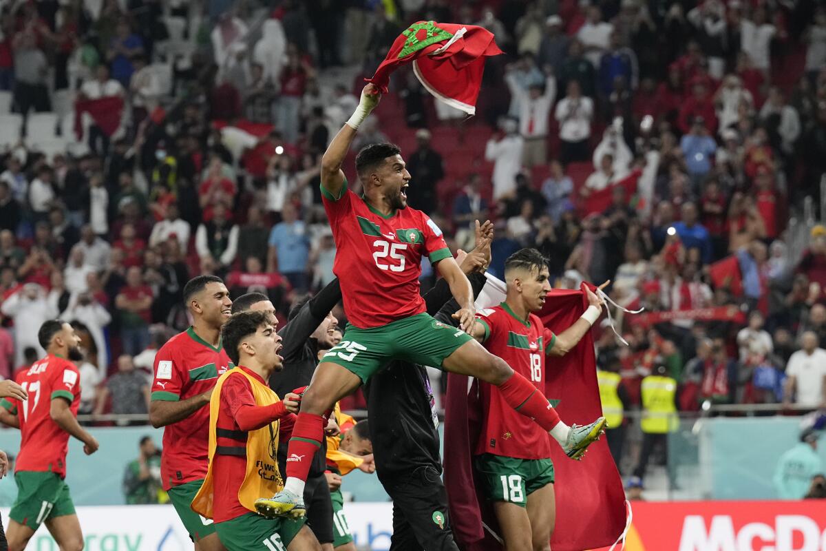 A Moroccan player is hoisted on his teammates' shoulders at the World Cup.