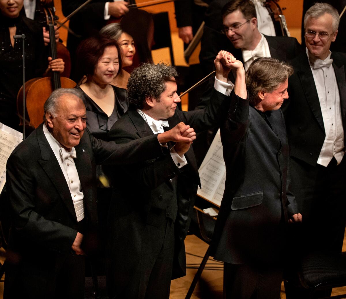 Zubin Mehta, left, Gustavo Dudamel and Esa-Pekka Salonen take a bow at the Disney Hall gala concert Thursday. 