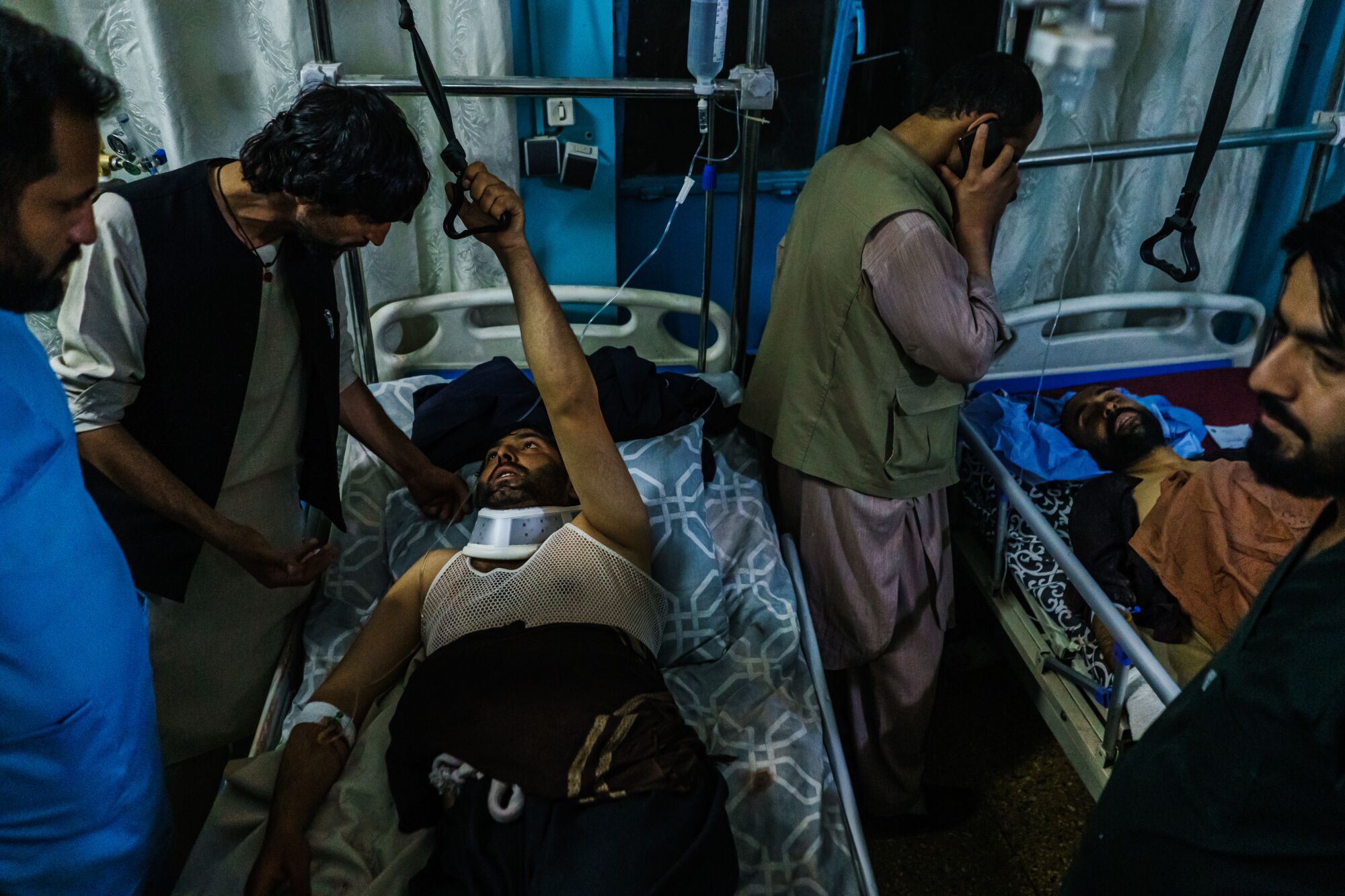 Family members visit wounded patients who have been admitted into Wazir Akbar Khan Hospital