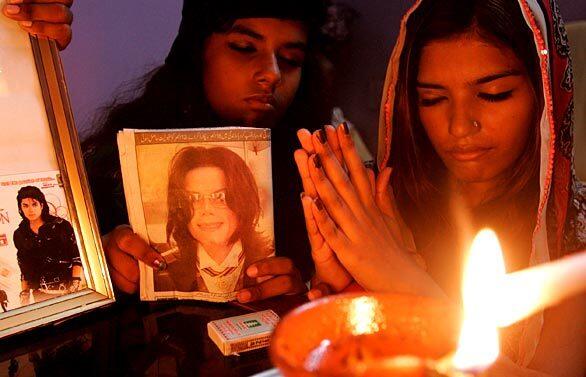 Christian girls in Karachi, Pakistan, participate in a candlelight memorial.