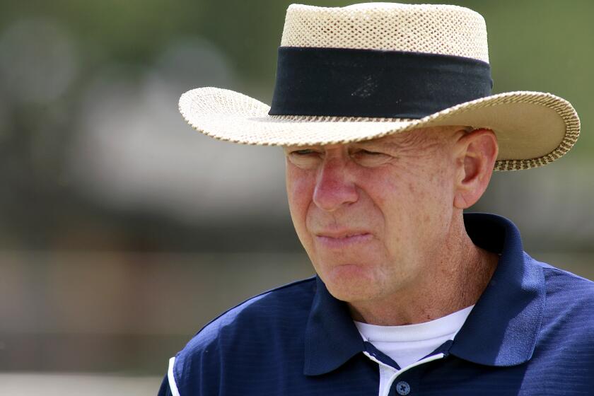 FILE - Odessa Permian head coach Gary Gaines walks off the practice field after a high school football workout in Odessa, Texas, May 21, 2009. Gaines, coach of the Texas high school football team made famous in the book and movie “Friday Night Lights,” has died. He was 73. Gaines’ family says the former coach died in Lubbock after a long battle with Alzheimer’s disease. (AP Photo/Kevin Buehler, File)