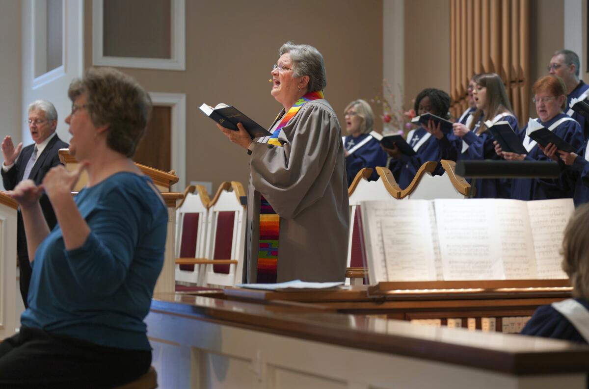 The Rev. Linda Barnes Popham sings with the choir 