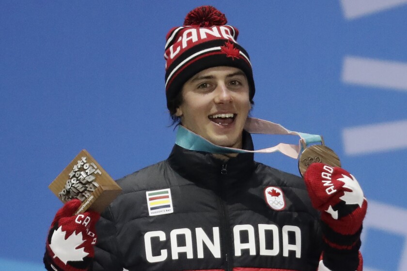 FILE - Men's slopestyle bronze medalist Mark McMorris, of Canada, smiles during the medals ceremony at the 2018 Winter Olympics in Pyeongchang, South Korea, Sunday, Feb. 11, 2018. McMorris has endured quite a pounding over more than a decade of hard riding that has made him Canada's most-decorated snowboarder. At 28 and heading into his third Olympics, he is missing one thing from an already awe-inspiring resume. (AP Photo/Morry Gash, File)