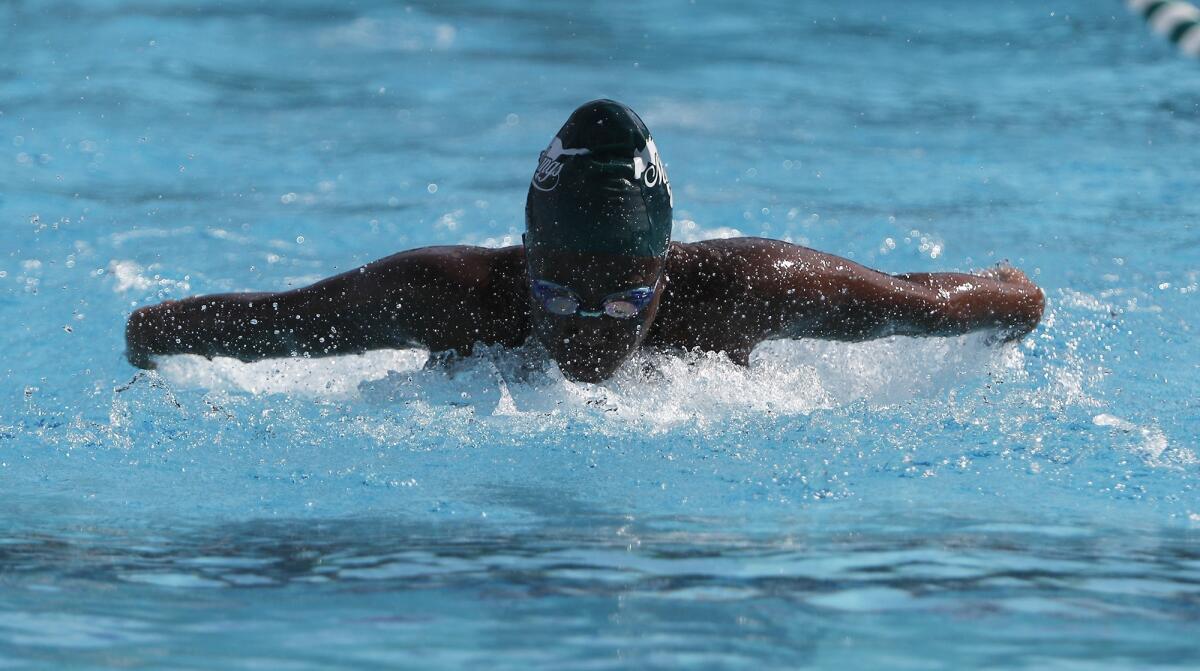 Costa Mesa High's Sey Currie competes in the girls' 100-yard butterfly race during an Orange Coast League swimming meet against Estancia at Costa Mesa on Wednesday.