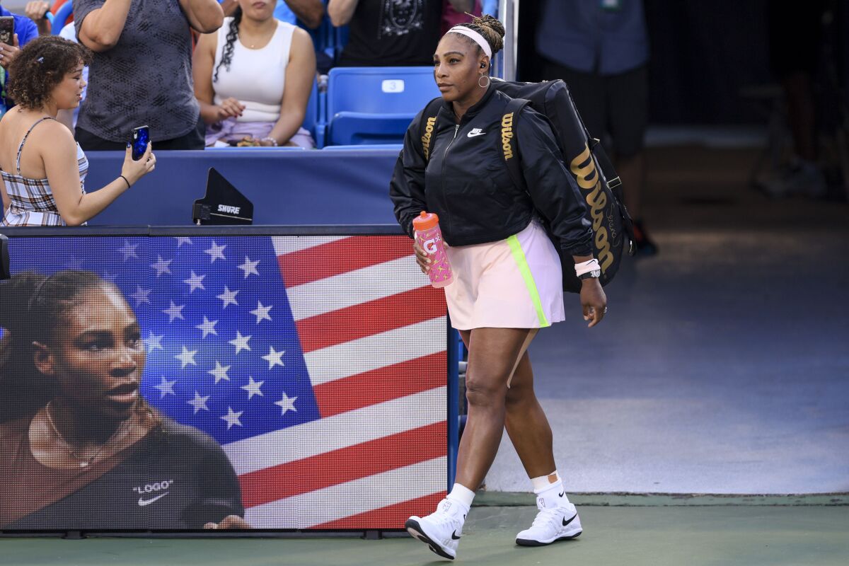 Serena Williams, of the United States, takes the court for a match against Emma Raducanu, of Britain, during the Western & Southern Open tennis tournament Tuesday, Aug. 16, 2022, in Mason, Ohio. (AP Photo/Aaron Doster)