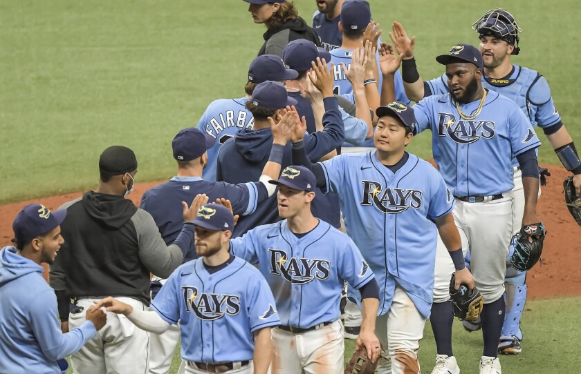 Tampa Bay Rays players, third from left to right, Brandon Lowe, Joey Wendle, Ji-Man Choi, Diego Castillo and Mike Zunino celebrate a win over the Philadelphia Phillies during a baseball game Sunday, May 30, 2021, in St. Petersburg, Fla. (AP Photo/Steve Nesius)