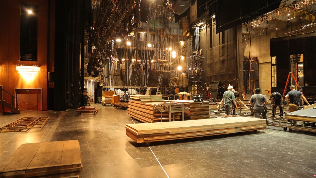 L.A. Opera’s stage crew members build a new set with wood pieces