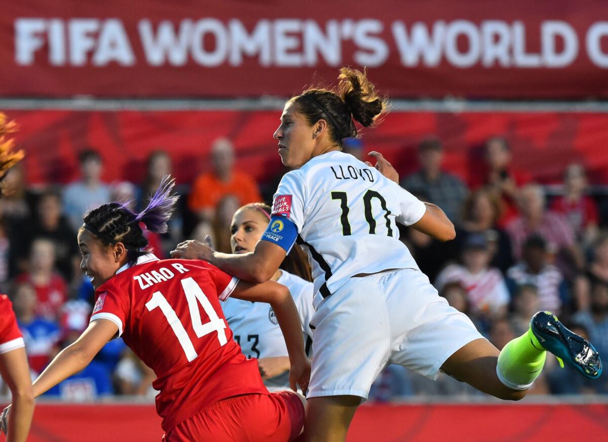 U.S. midfielder Carli Lloyd watches her header over China's Rong Zhao go into the net for a goal in the second half of a Women's World Cup quarterfinal on Friday at T.D. Place in Ottawa.