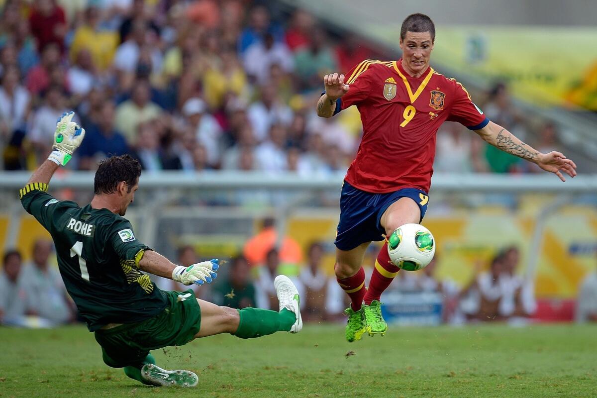 Fernando Torres of Spain goes past Mickael Roche of Tahiti on his way to scoring one of his four goals during his team's 10-0 victory Thursday.