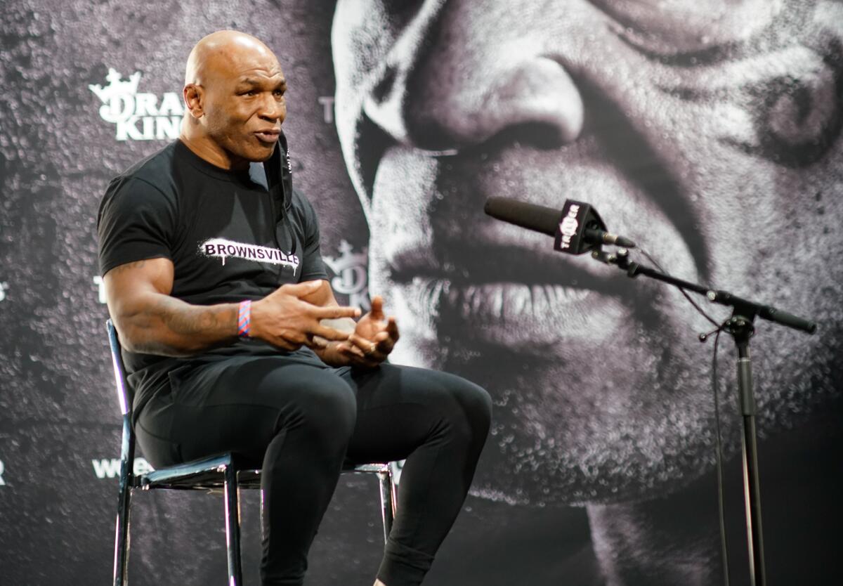 Mike Tyson speaks at his weigh-in at the JW Marriott in downtown Los Angeles on Nov. 27, 2020. 