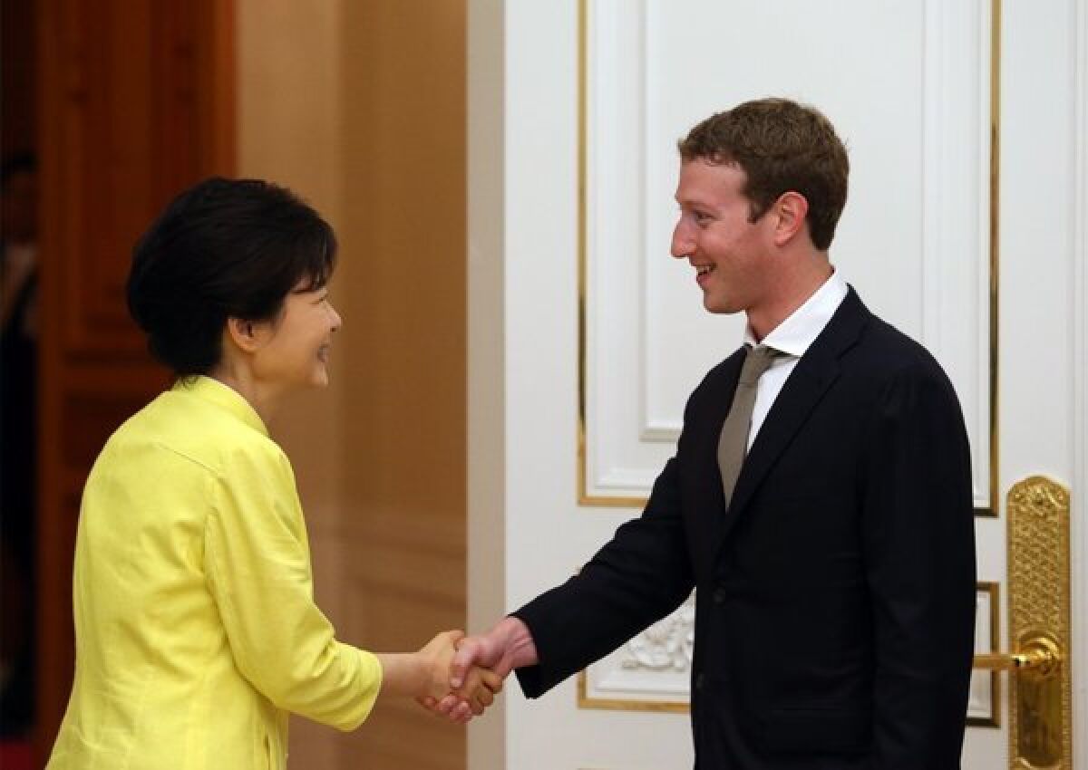 South Korean President Park Geun-hye, left, shakes hands with Facebook CEO Mark Zuckerberg during a meeting at the presidential house in Seoul.