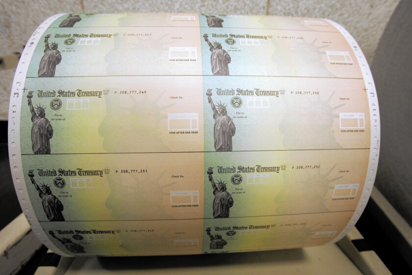 Blank U.S. Treasury checks are seen on a roll at the Philadelphia Financial Center in May of 2008.