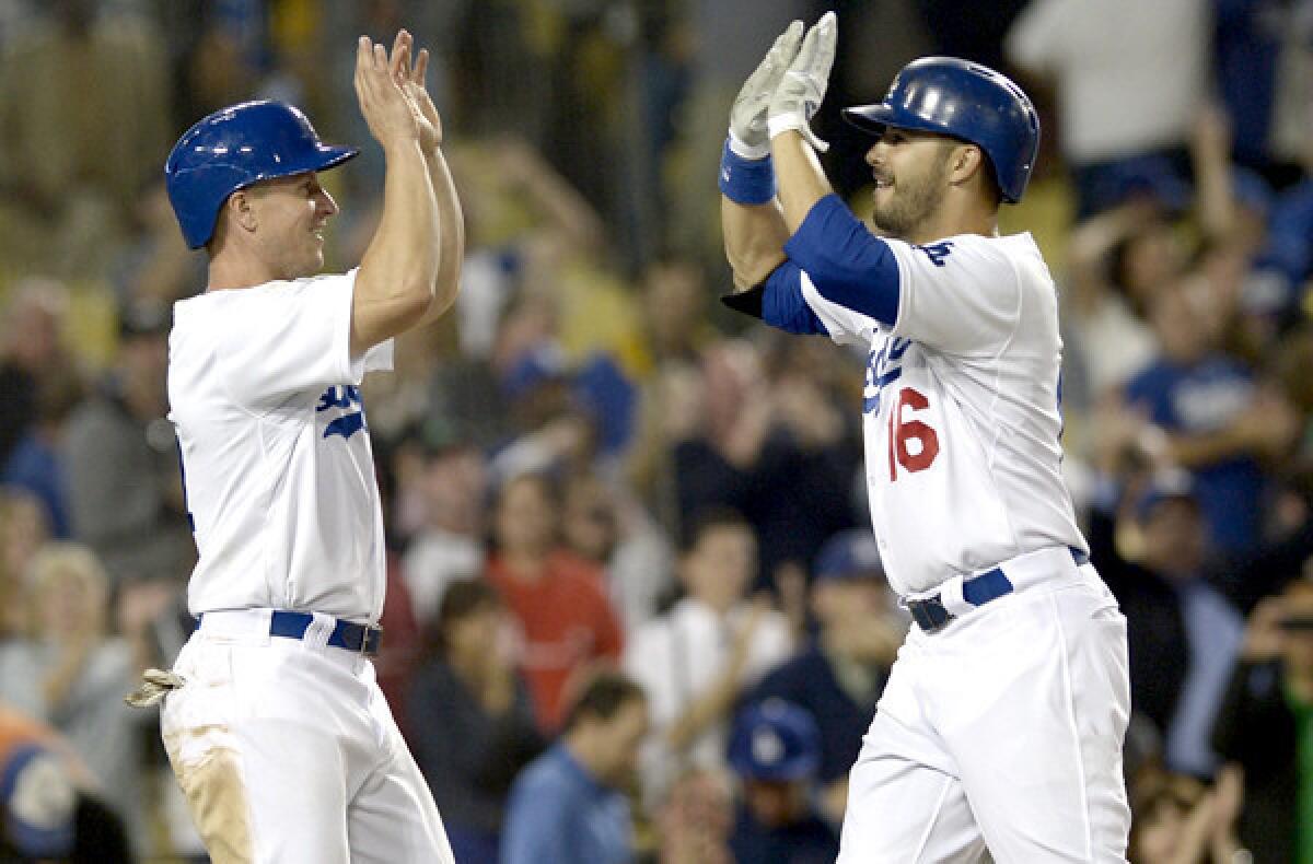 Dodgers pinch-hitter Andre Ethier (16) is congratulated by second baseman Mark Ellis after hitting a two-run home run in the ninth inning to tie the score against the Mets, 4-4.