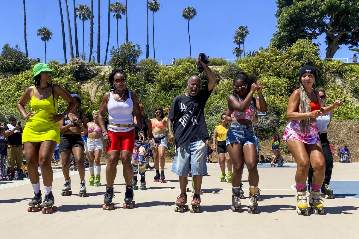 A group of people roller skating in a line