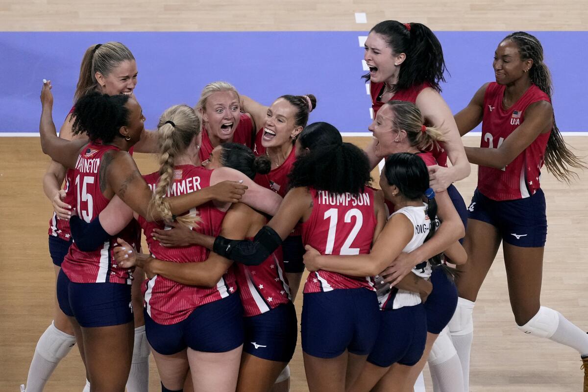 U.S. players celebrate after beating Brazil in a 2024 Summer Olympics women's volleyball semifinal match Thursday 