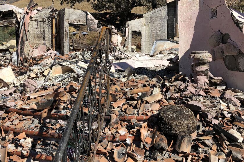Broken roof tiles litter a staircase of an Airbnb rental home in the Santa Monica Mountains that was destroyed in the 2018 Woolsey fire.