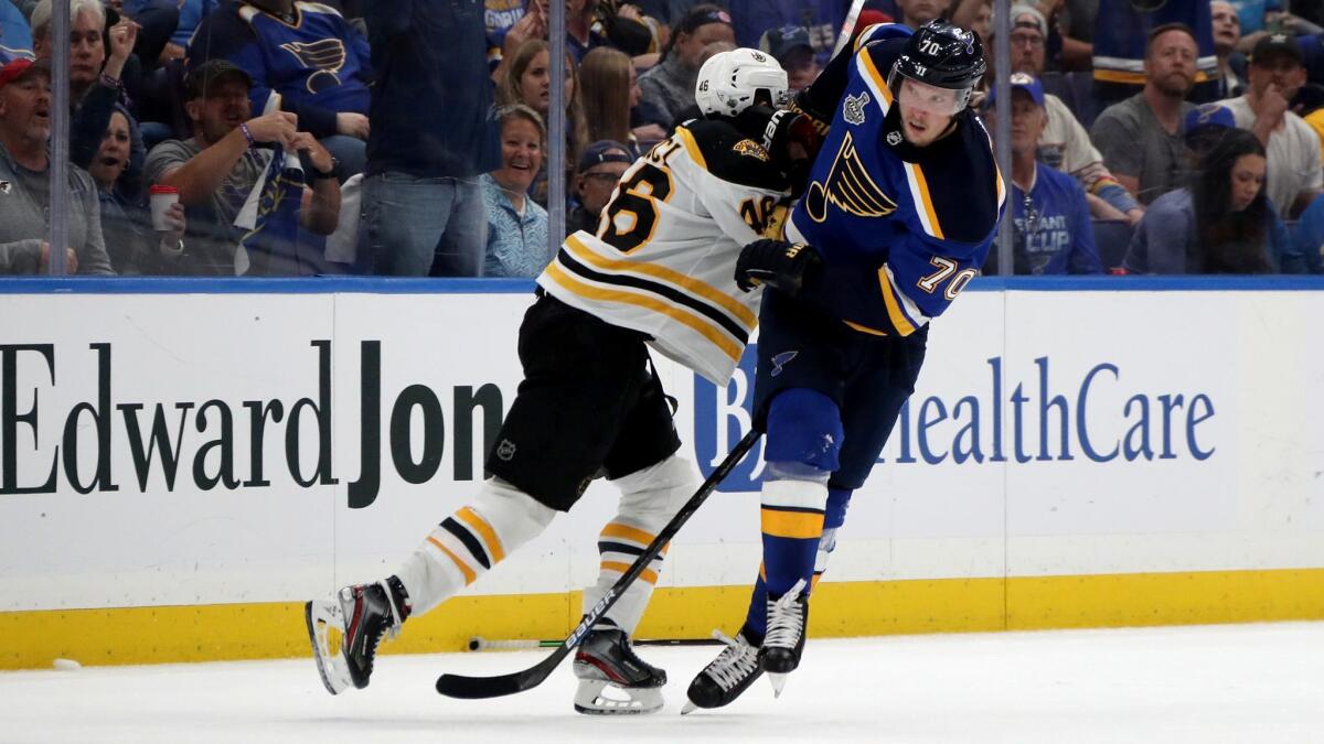 St. Louis Blues' Oskar Sundqvist (70) gets tangled up with Boston Bruins David Krejci (46) in Game 4 of the Stanley Cup Final on Monday in St. Louis.