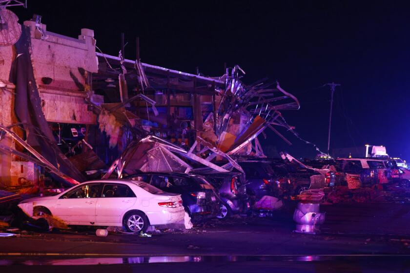 Several cars are seen heavily damaged outside the remains of a Shell gas station after a suspected tornado, Sunday, May 26, 2024, in Valley View, Texas. Powerful storms killed at least seven people and left a wide trail of destruction Sunday across Texas, Oklahoma and Arkansas after obliterating homes and destroying a truck stop where drivers took shelter during the latest deadly weather to strike the central U.S. (Elías Valverde II/The Dallas Morning News via AP)