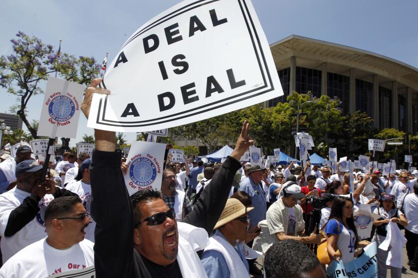 Hundreds of union workers from the International Brotherhood of Electrical Workers Local 18 flooded a section of downtown Los Angeles to protest what they characterized as a threat by city leaders to withhold an upcoming payment to two nonprofit training organizations affiliated with the Department of Water and Power.